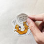 Hand applying Cat-ch Me If You Can illustrated vinyl sticker.
