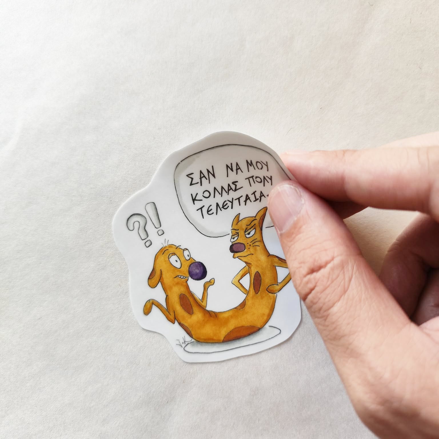 Hand applying Cat-ch Me If You Can illustrated vinyl sticker.