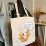 Cat-ch Me If You Can illustrated tote bag displayed in a lifestyle setting.