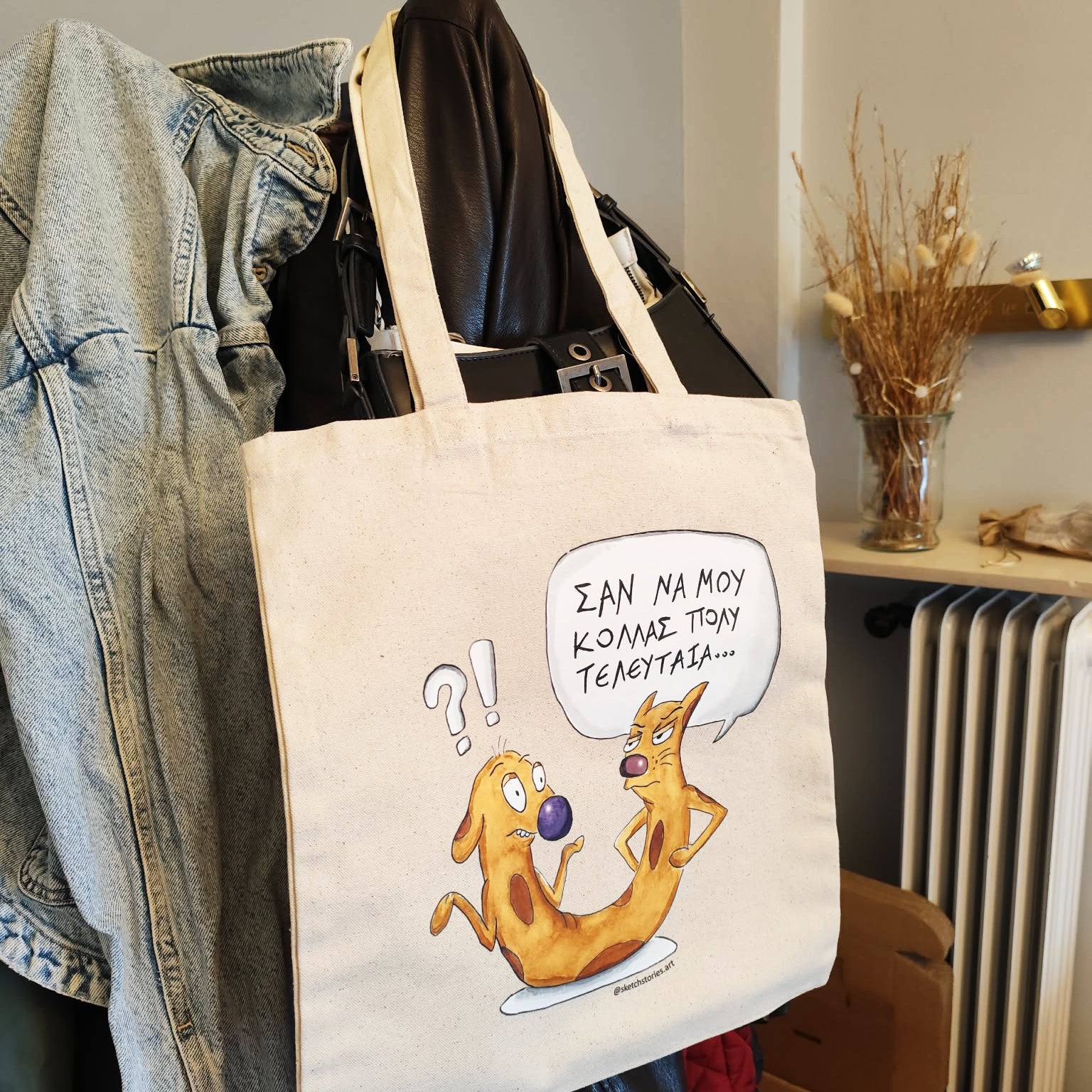 Cat-ch Me If You Can illustrated tote bag displayed in a lifestyle setting.