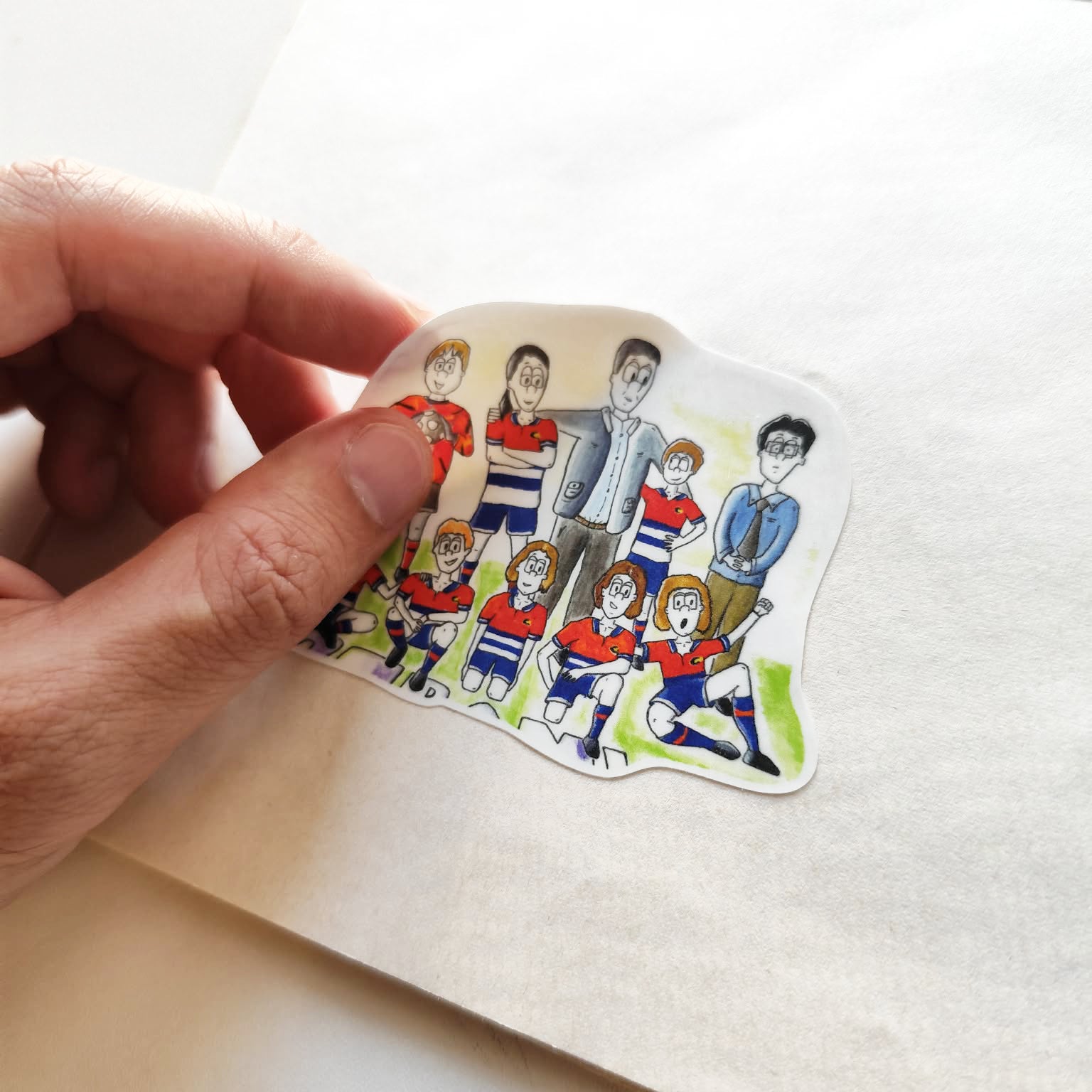 Hand applying Cebollitas illustrated vinyl sticker.