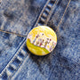 Childhood Days illustrated pin button attached to a denim jacket.