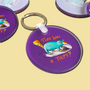 Acrylic keychain with the hand-drawn "Exhausted Spy" design by Sketch Stories.
