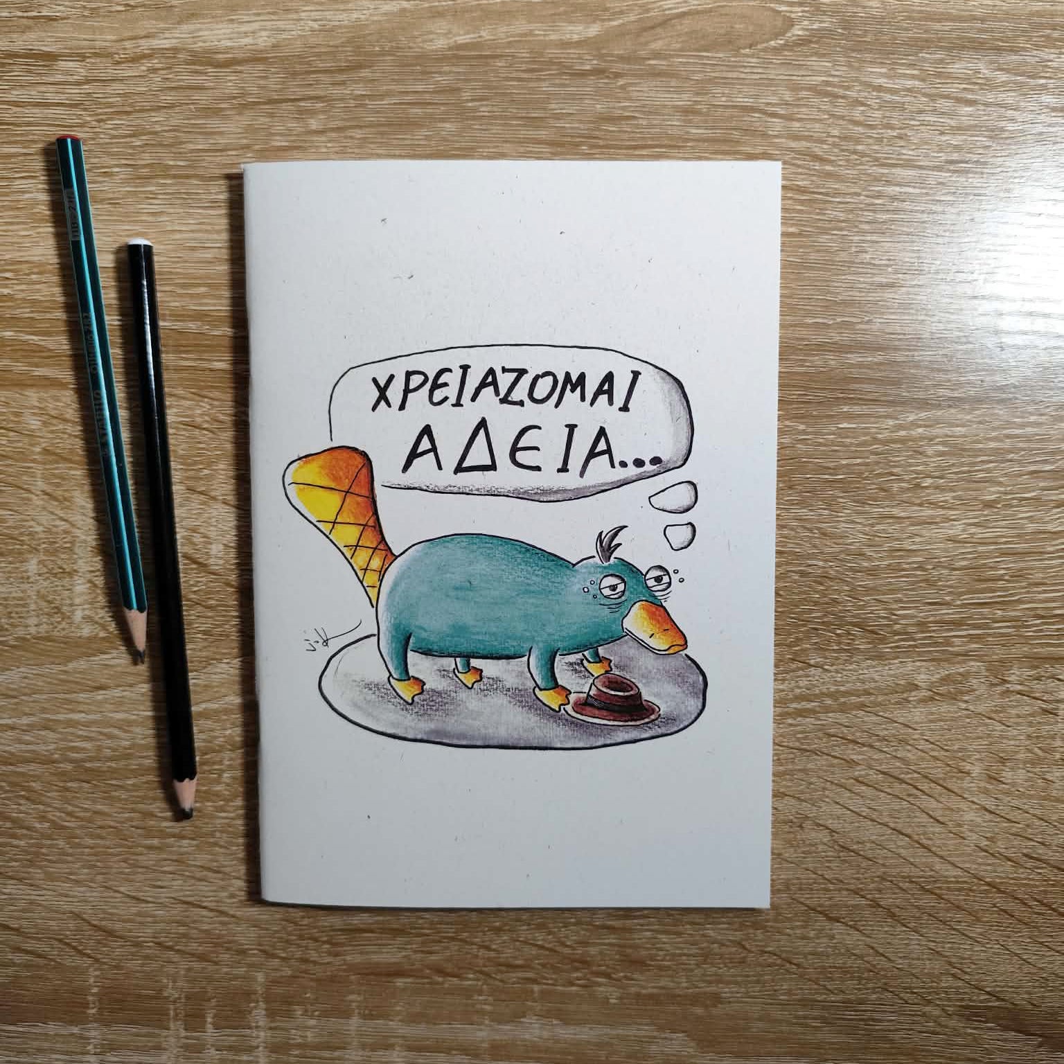 Exhausted Spy illustrated notebook displayed on a creative workspace.