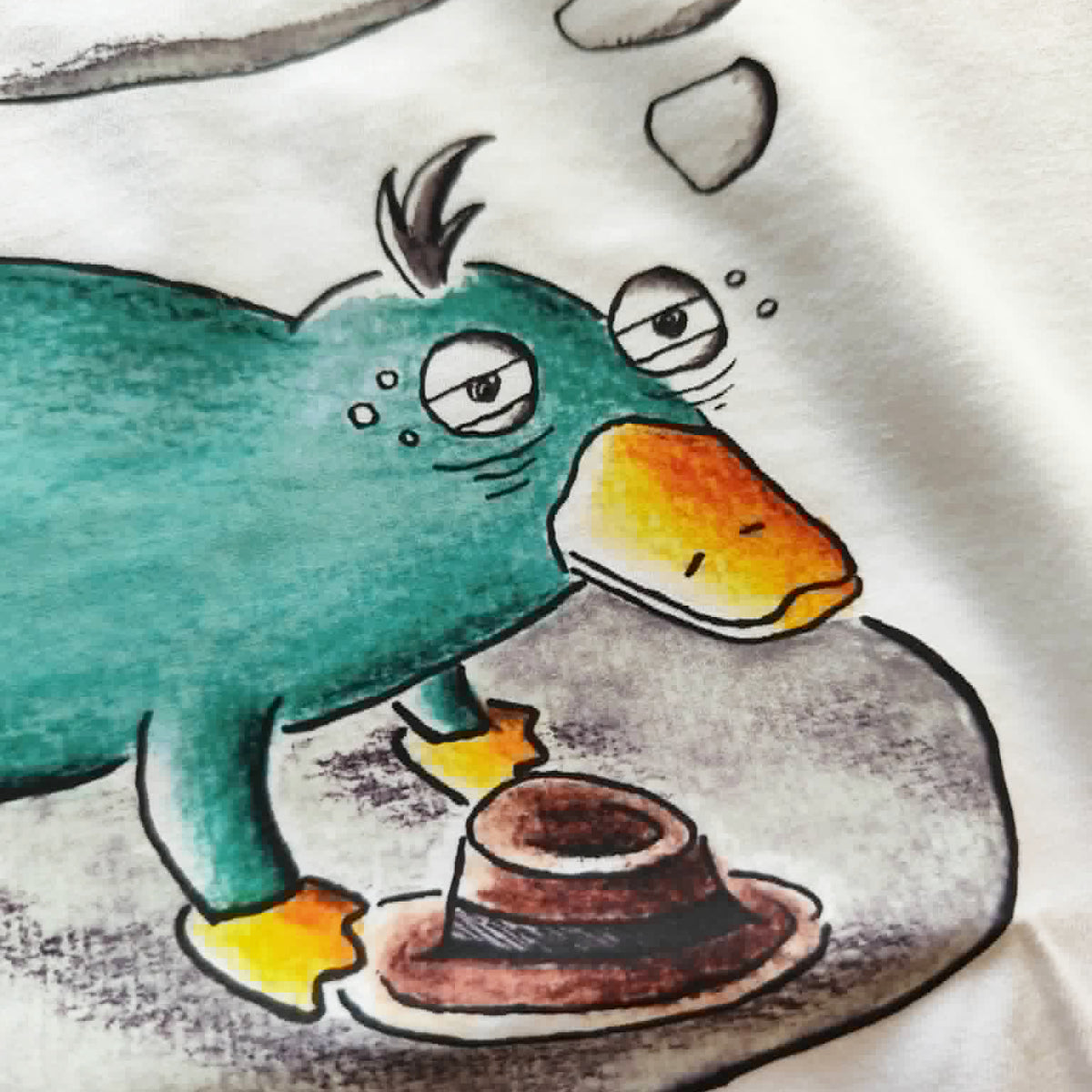 Close-up of the hand-drawn "Exhausted Spy" illustration printed on a white unisex t-shirt.
