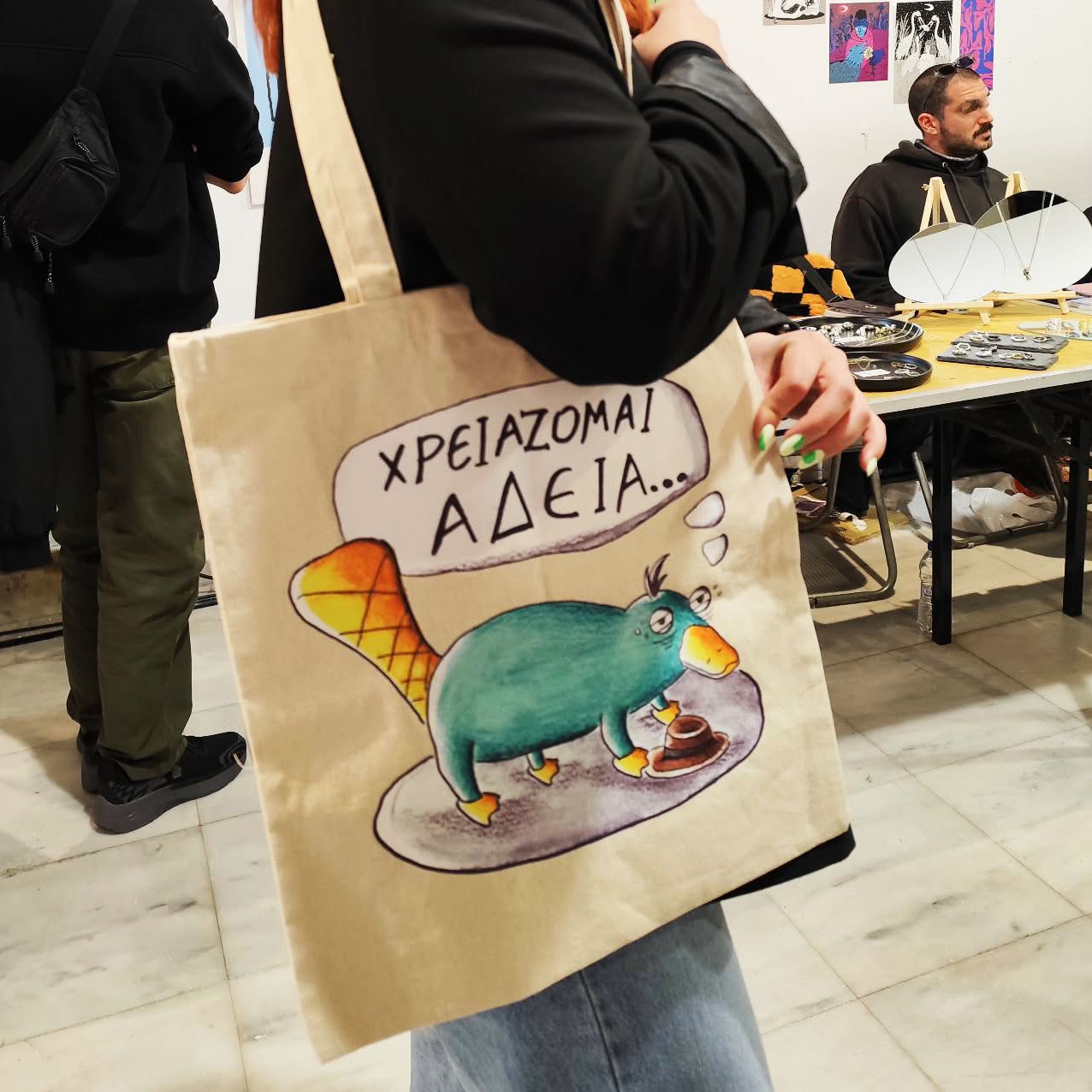 Exhausted Spy illustrated tote bag displayed in a lifestyle setting.