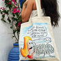 Ikarian Dance illustrated tote bag displayed in a lifestyle setting.