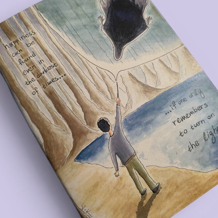 Close-up of the Light in the Darkness illustration on an A5 notebook cover.