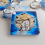Close-up of the Never Grow Up acrylic keychain by Sketch Stories.