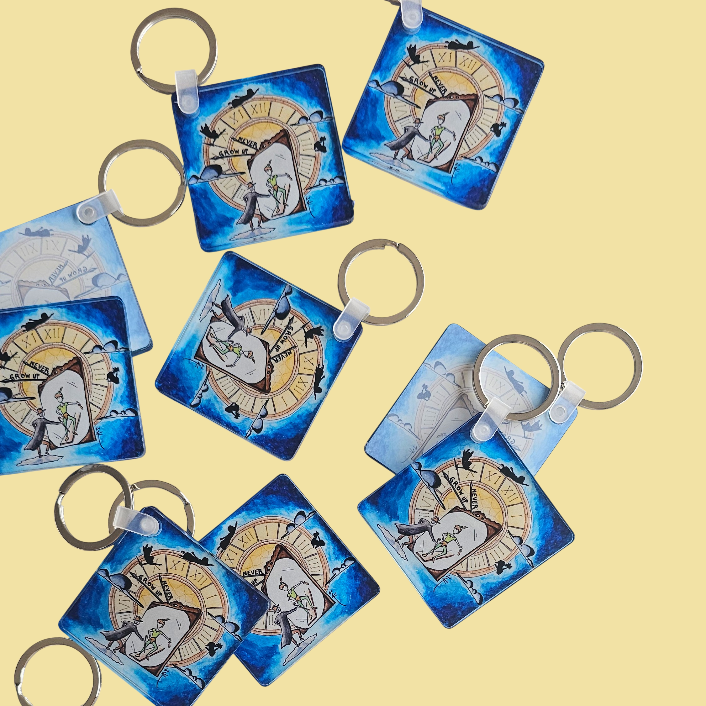 Flat lay of Never Grow up acrylic keychains by Sketch Stories.
