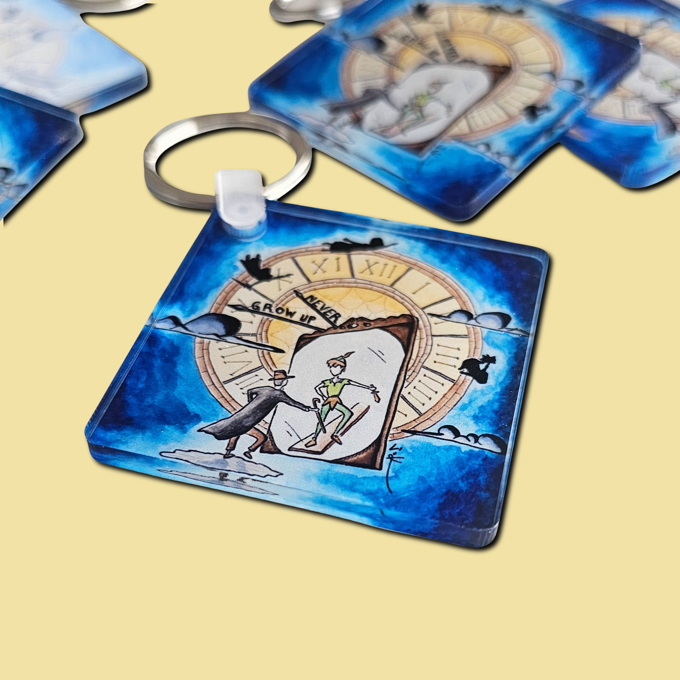 Acrylic keychain with the hand-drawn "Never Grow Up" design by Sketch Stories.
