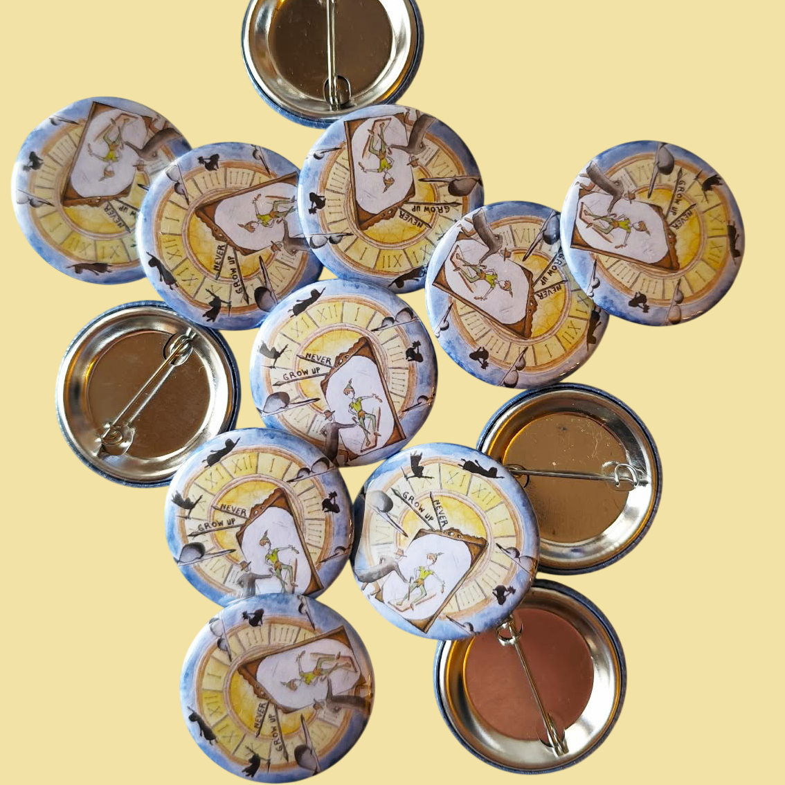Never Grow Up illustrated pin button displayed with other illustrated pin buttons by Sketch Stories.