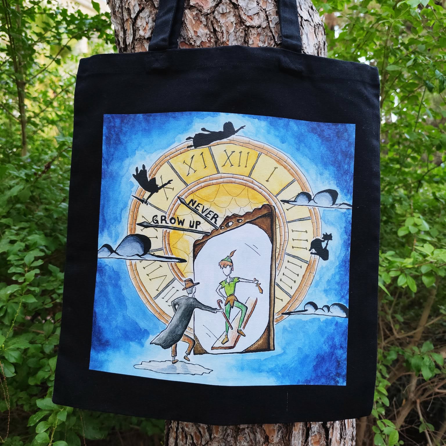 Never Grow Up illustrated tote bag displayed in a lifestyle setting.