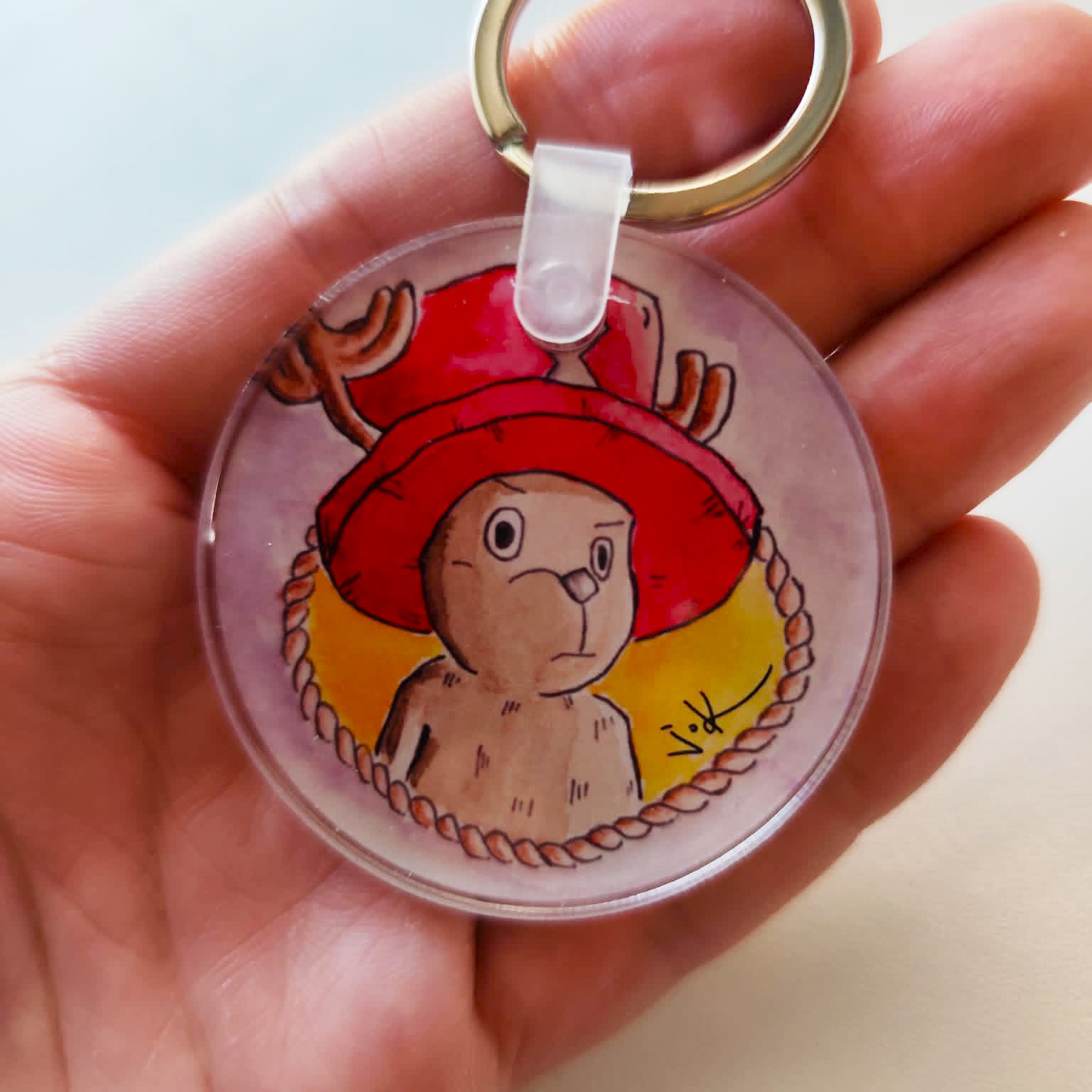 Reindeer Companion acrylic keychain held in hand for size reference.