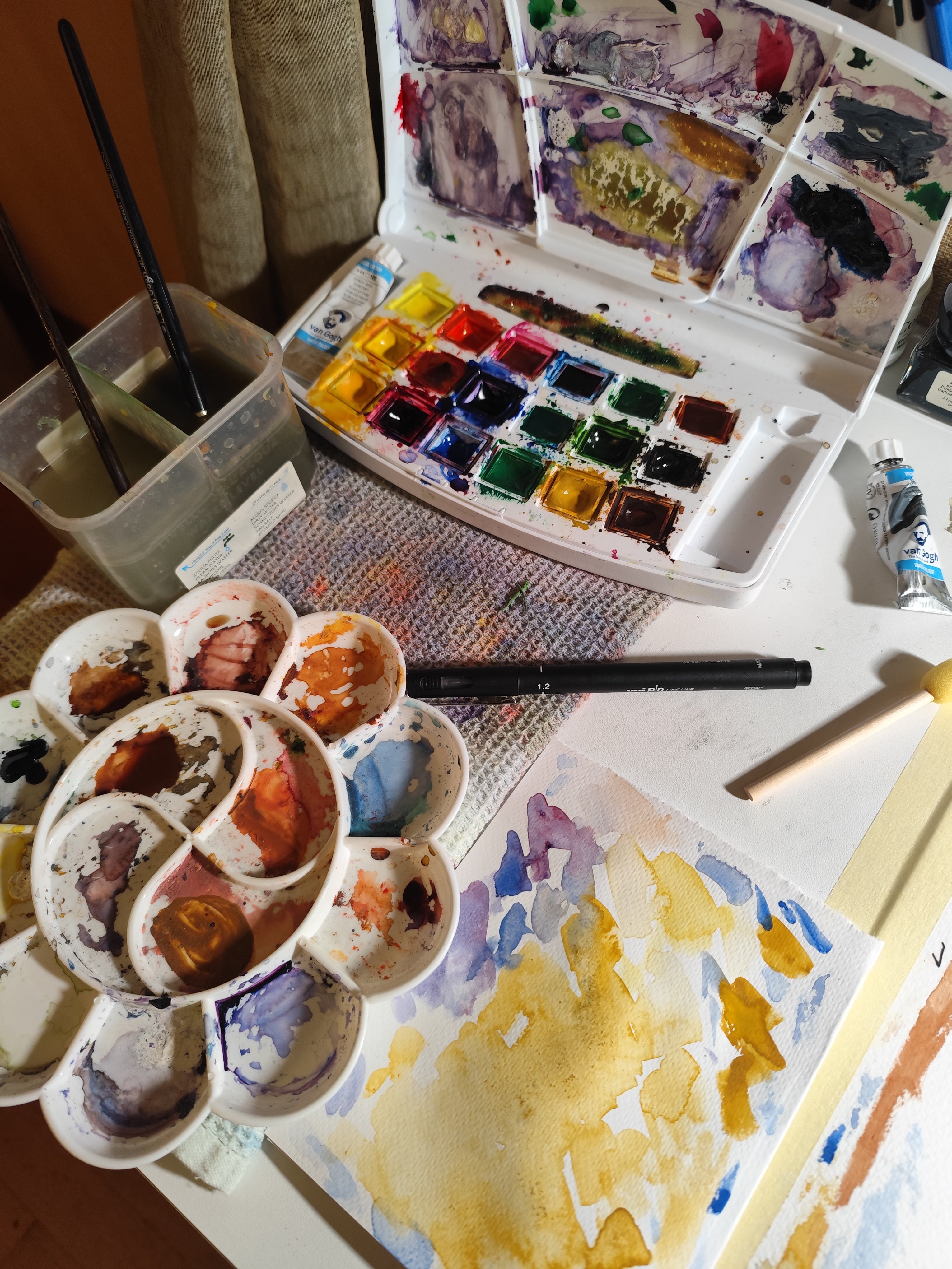 Watercolor painting workspace with brushes, paints and hand-drawn artwork by Sketch Stories